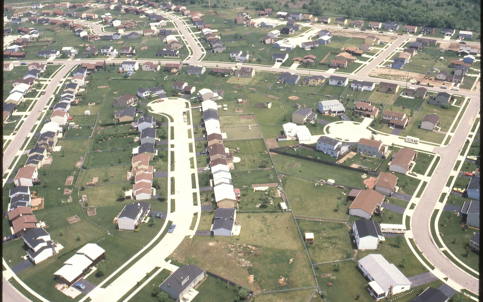 Aerial photograph of a residential neighborhood showing suburban homes and streets from above